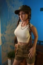 Realistic sex doll with detailed facial features and long braided hair, dressed in casual urban clothing.