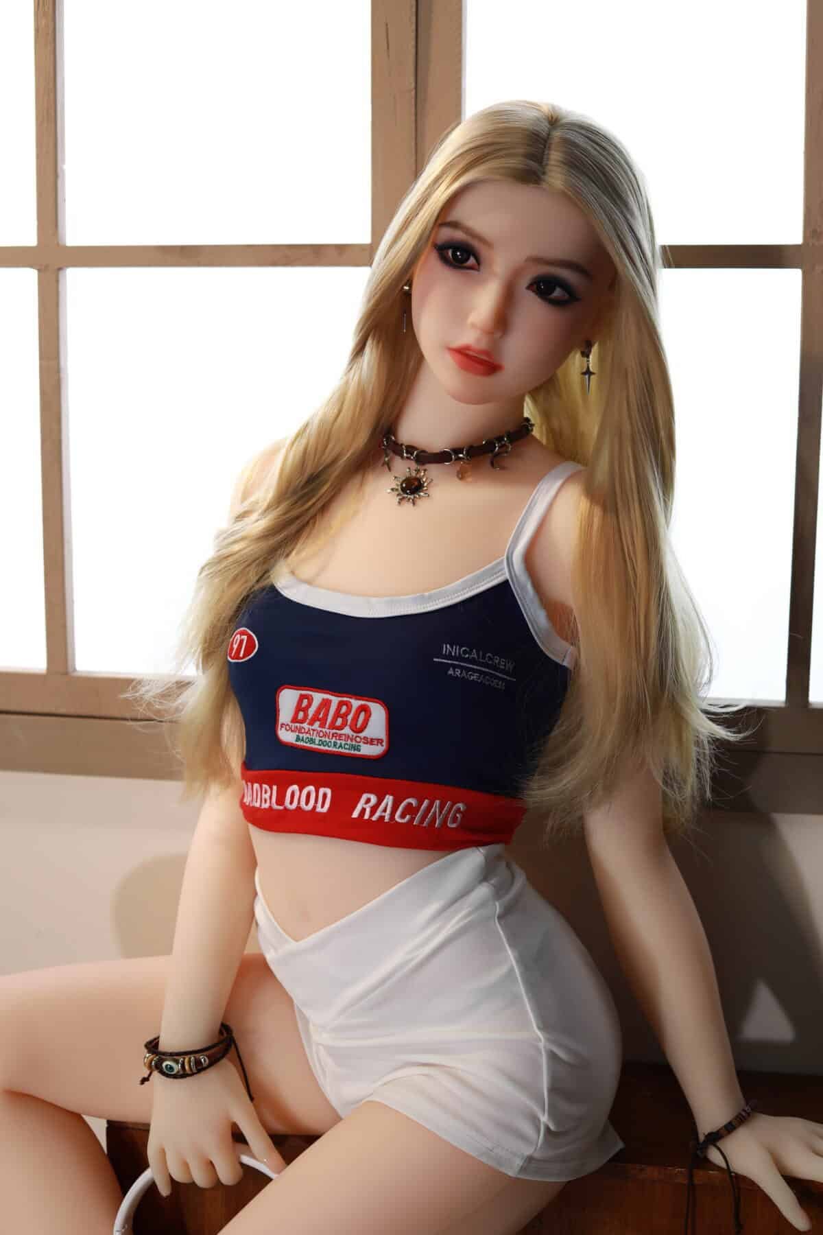Realistic sex doll with anime-inspired features, blonde hair, and detailed clothing.