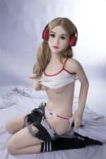 Realistic sex doll wearing headphones, casual style, and minimal clothing, seated on a bed.
